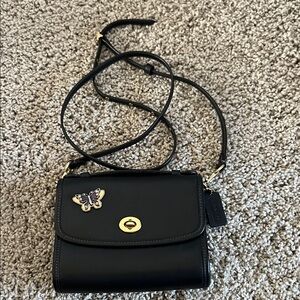Chic Coach Black Crossbody Bag with Butterfly Accent